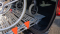 manual wheelchair being pushed up a rollable ramp into the boot of a car - close up of the rest on connection