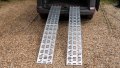 Pair of motorbike loading ramps resting on vehicle boot