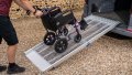 Manual wheelchair going up FEAL AnyRamp into a vehicle