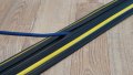 1 channel black and yellow cable protector on a wooden floor with a cable 