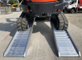 rubber tracked machinery loaded on ramps 