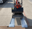 Mini Digger driving up ramps 