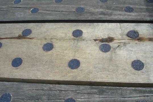 Black discs on timber