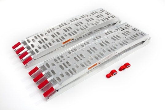 Pair of motorbike loading ramps folded up on white surface