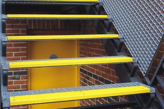 Yellow stair treads on metal staircase 