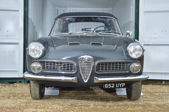 Car driving off of loading ramps 