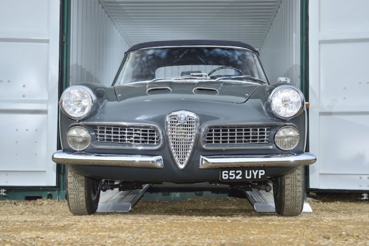 Vintage car on aluminium loading ramps 