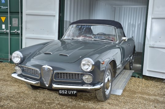 Vintage car on aluminium loading ramps 