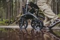 All terrain rollator being used in woodland through a puddle 