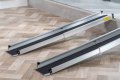 Telescopic wheelchair ramps resting on step 