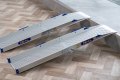 Folding wheelchair ramps resting on step