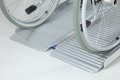 Wheelchair going up portable wheelchair ramp 