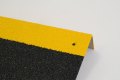 Black and yellow anti-slip stair treads with pre-drilled fixing points 
