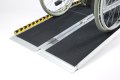 Black anti-slip surface on the folding wheelchair ramp 