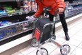 Lady shopping with the Trust Care outdoor rollator 