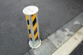 Telescopic bollard on driveway installed in tarmac 