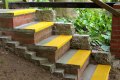 Yellow stair treads with nosing on concrete steps 