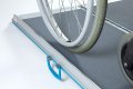Manual wheelchair on portable wheelchair ramp with antiskid surface 