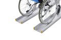 Manual wheelchair going up a pair of channel ramps 