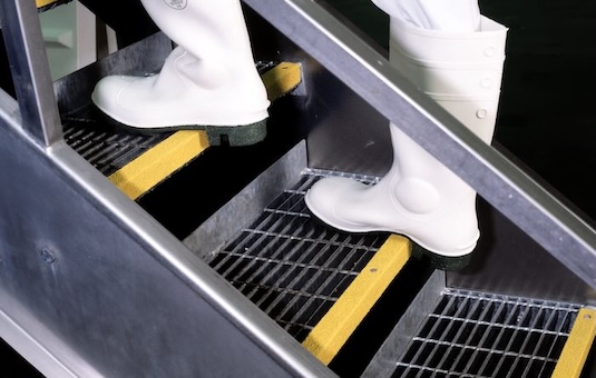 Person walking up metal steps with Yellow Stair Nosing 