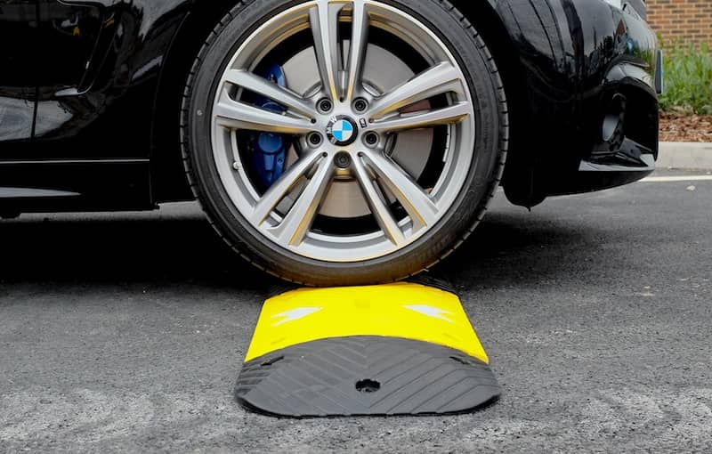 Car driving over speed bumps 