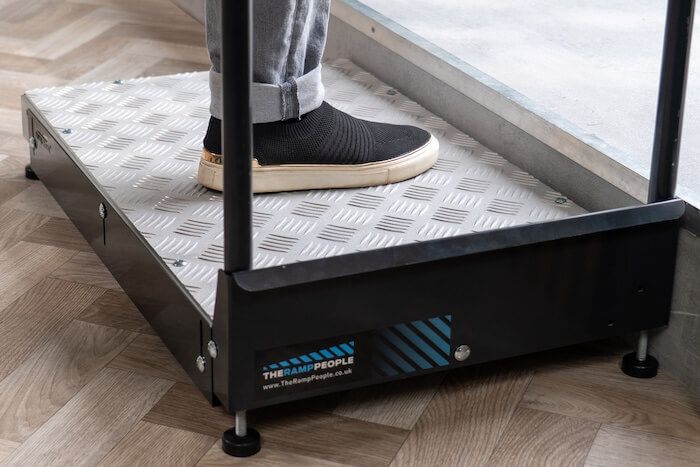 Adjustable half step with handrail