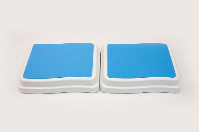 Two plastic bath steps side by side