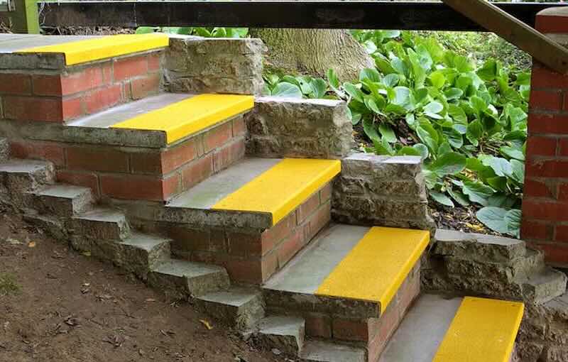 Yellow Stair Tread Covers on Outdoor Concrete Steps 